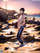 A woman in a wet suit standing on a beach.