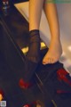 A close up of a person's feet in black stockings.