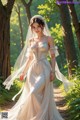 A woman in a wedding dress walking down a path in the woods.