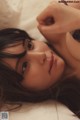 A woman laying on top of a bed in lingerie.
