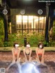 A group of three women sitting in a hot tub.